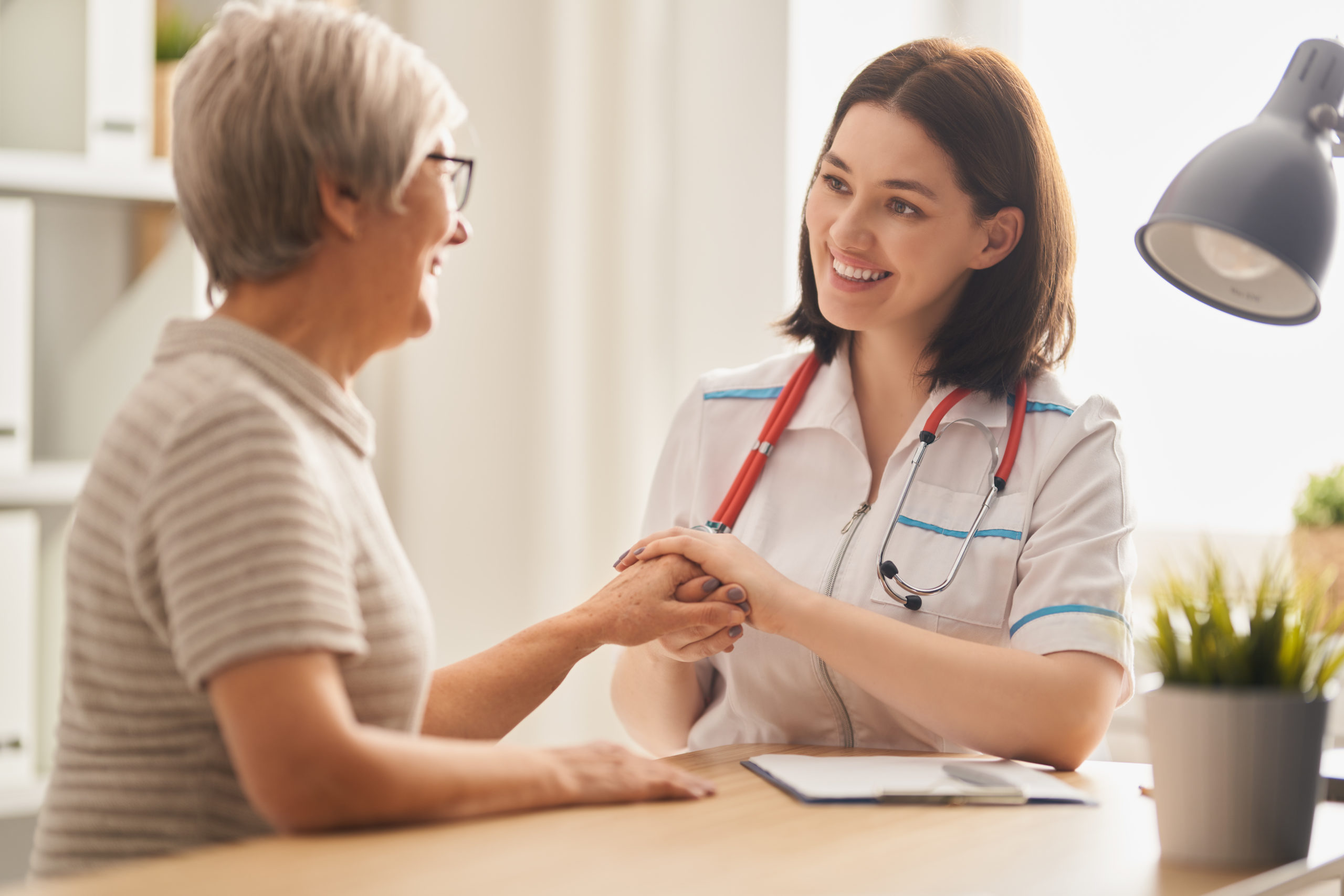 A compassionate nurse assisting an elderly patient at home, symbolizing quality home healthcare services in Georgia.